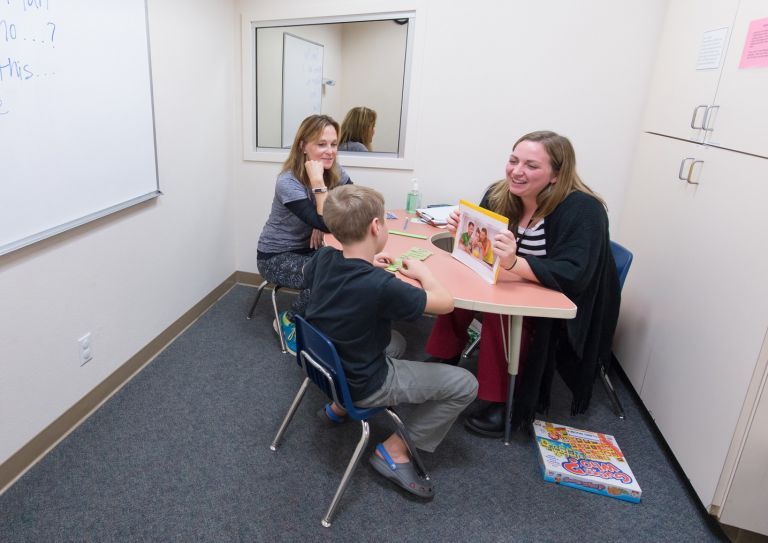 child works with Samantha Sheppard at the Scottish Rite Childhood Language Disorders Center.