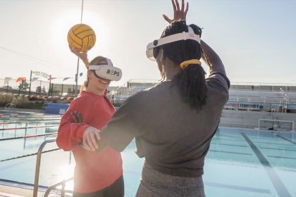 two water polo players demonstrate virtual reality equipment