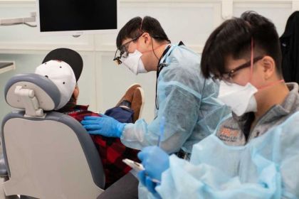 dental students work with a patient